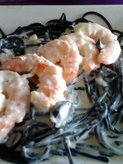 A picture of Gambas with black Spaghetti.