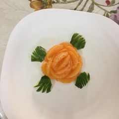A picture of Rose flower with orange slices.
