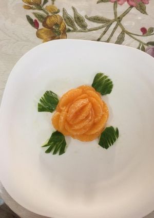 A picture of Rose flower with orange slices.