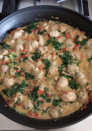 A picture of Sausage with Tomatoes & Kale in Cheddar Cheese Sauce.