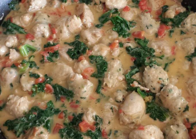 Sausage with Tomatoes & Kale in Cheddar Cheese Sauce
