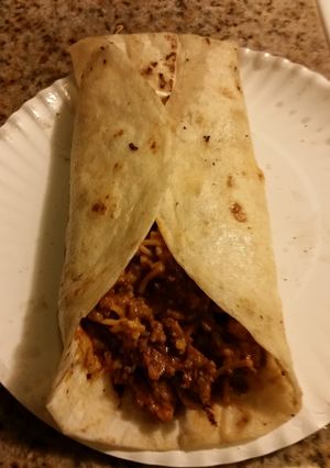 A picture of Cheesy Rice and beef burrito.