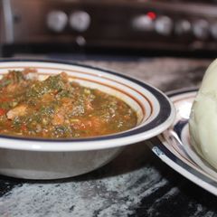 Pounded yam with vegetable soup A picture of Pounded yam with vegetable soup.