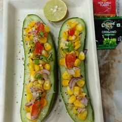 A picture of Sweet corn chat in cucumber boat.