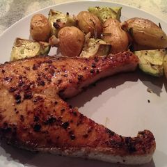 A picture of Peri peri salmon with roasted rosemary potatoes and avocados.