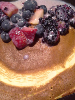 A picture of Pancakes with fruits.