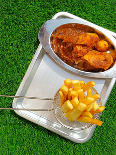 A picture of Yam fingers with spicy chicken sauce.