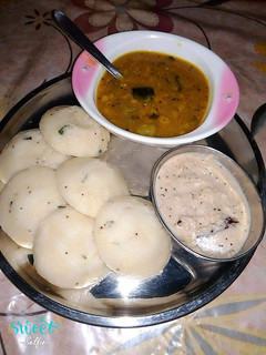 A picture of Suji idli with sambhar or chutney.