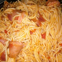 A picture of Threaded spaghetti hot dog bites in sauce.