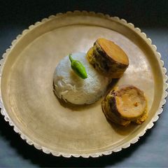 A picture of Aubergine dipped in Besan or Chickpea flour / Pur Bhora Begun Bhaaja in Thakurbari style.