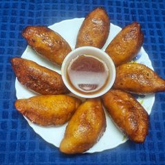 A picture of Moong Shamli or Moong Fried Dumplings.