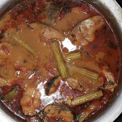 A picture of Fish curry with mango and drumstick.