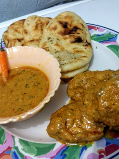 A picture of Buttered garlic naan & chicken curry.