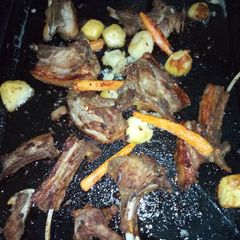 A picture of Roasted pork chops with carrots and potatoes.