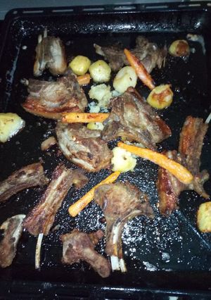 A picture of Roasted pork chops with carrots and potatoes.