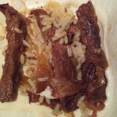 A picture of Steak Fajitas with Queso Cheese Sauce.
