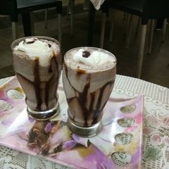 A picture of Chocolate milk with icecream scoop.