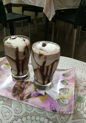 A picture of Chocolate milk with icecream scoop.