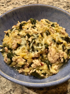 A picture of Creamy Orzo with turkey and spinach.