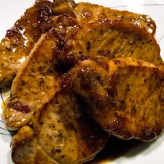 A picture of Pork chops with lingonberry and rosemary pan sauce.