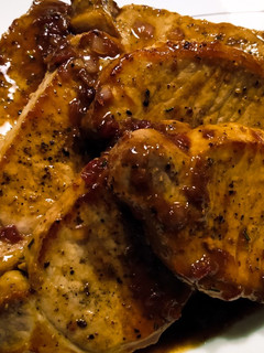 A picture of Pork chops with lingonberry and rosemary pan sauce.