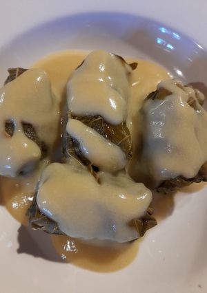 A picture of Dolmades with Grape Leaves and Avgolemono Sauce.