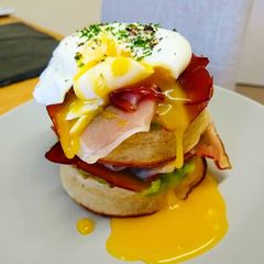 A picture of Smoked Ham & Minted Pea Crumpet Stack with Poached Egg.