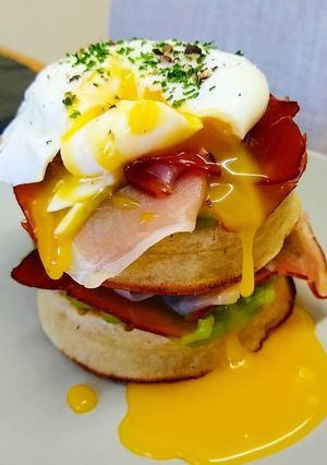 A picture of Smoked Ham & Minted Pea Crumpet Stack with Poached Egg.