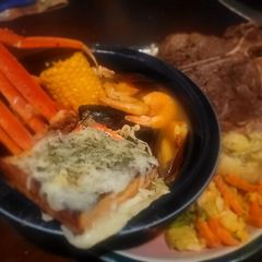 A picture of Home-cooked Surf-n-Turf (seafood and steak w/sides).
