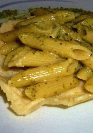 A picture of Penne with Gorgonzola and Genovese Pesto served in a Parmesan Basket.