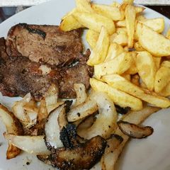 A picture of My Well done Peppered Ribeye Steak with onions.
