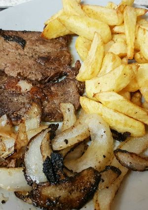 A picture of My Well done Peppered Ribeye Steak with onions.