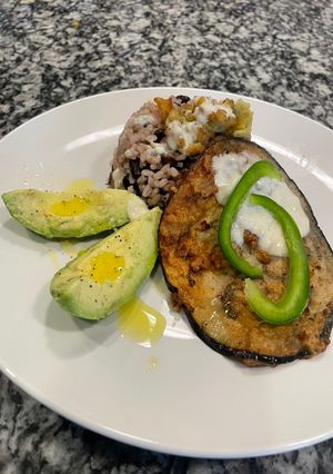 A picture of Fry eggplant with rice and black beans.