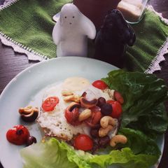 A picture of Fried egg with roasted nuts.