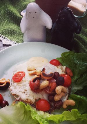 A picture of Fried egg with roasted nuts.
