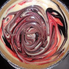 A picture of chocolate and strawberry cheesecake.