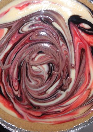 A picture of chocolate and strawberry cheesecake.
