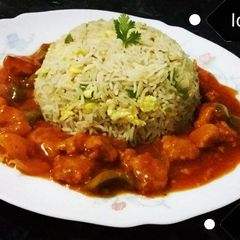 A picture of Chicken Manchurian with fried rice.