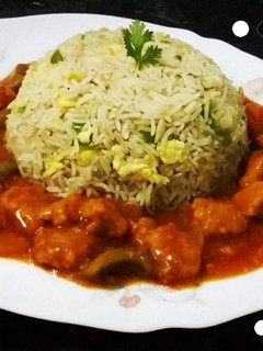 A picture of Chicken Manchurian with fried rice.