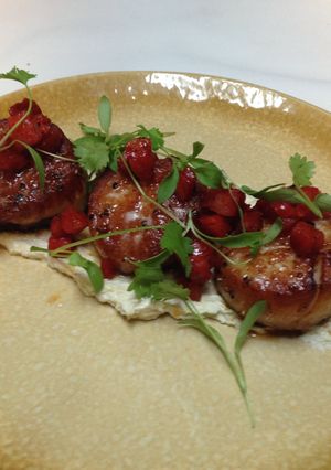 A picture of pan seared diver scallops with roasted artichoke,Chevre puree and fried chorizo.