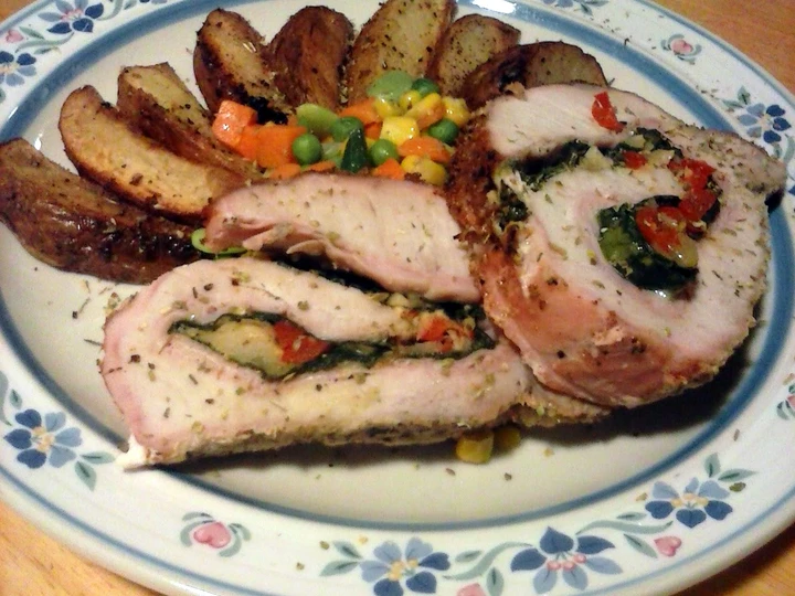 Recipe spinach and pepper stuffed pork loin with parmesan potato wedges and mixed veggies which Delicious