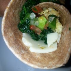 A picture of Chicken, spinach, pico de gallo wrap.