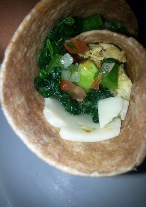 A picture of Chicken, spinach, pico de gallo wrap.