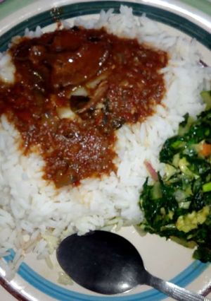 A picture of Rice and stew with vegetable.