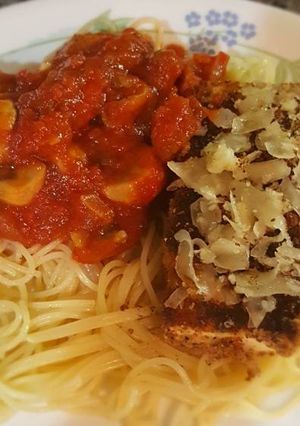 A picture of Tofu parm with mushroom marinara sauce, angel hair pasta.