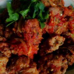 A picture of Meatballs with fresh tomatoes sauce.