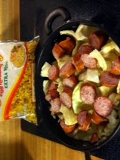 A picture of Fried cabbage and noodles with kielbasa.