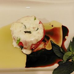 A picture of Hot Caprese Style Stuffed Tomatoes.