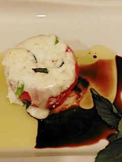 A picture of Hot Caprese Style Stuffed Tomatoes.