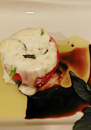 A picture of Hot Caprese Style Stuffed Tomatoes.